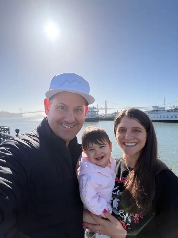 Alan and Jamie with their daughter by the water